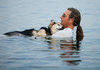 Arthritic dog soothed to sleep in a lake